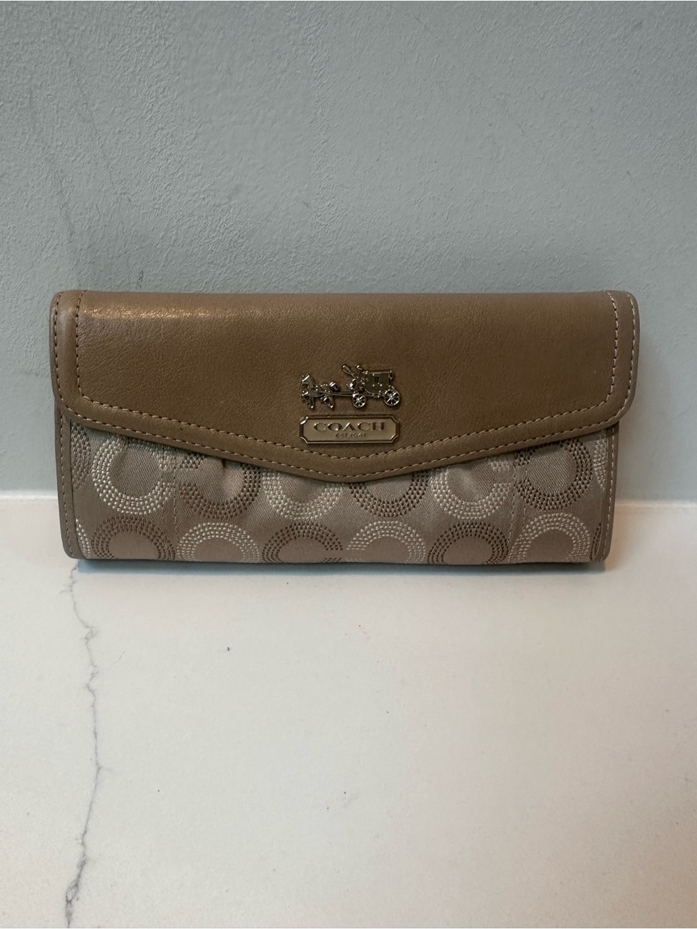Coach Madison Optic C logo wall with horse and carriage logo